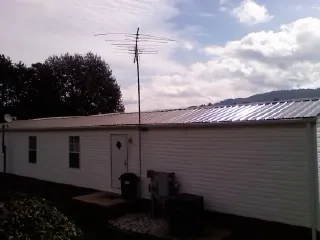 New metal roof on a single wide mobile home with a TV antenna in New Tazewell